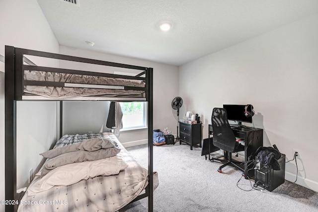 carpeted bedroom featuring a textured ceiling