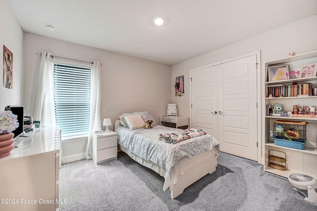 carpeted bedroom with a closet