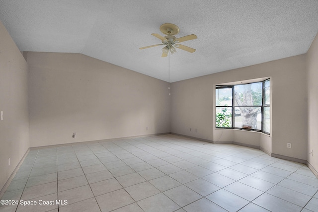 unfurnished room featuring light tile patterned floors, a textured ceiling, vaulted ceiling, and ceiling fan