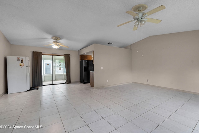 unfurnished living room with light tile patterned floors, a textured ceiling, vaulted ceiling, and ceiling fan