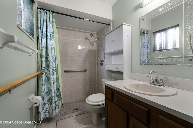 bathroom with tile patterned flooring, vanity, toilet, and walk in shower