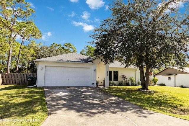 single story home featuring a front yard and a garage