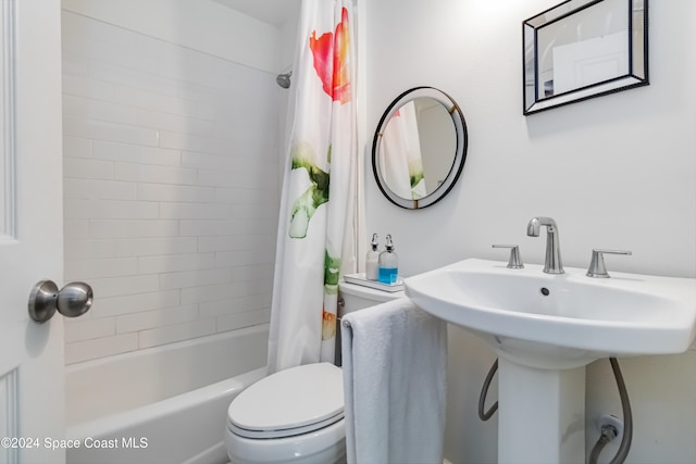 bathroom featuring shower / bathtub combination with curtain and toilet