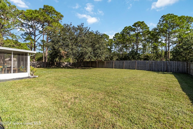 view of yard featuring a sunroom