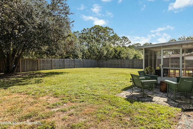 view of yard featuring a patio area and a sunroom