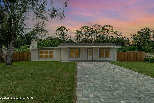 ranch-style house featuring a yard