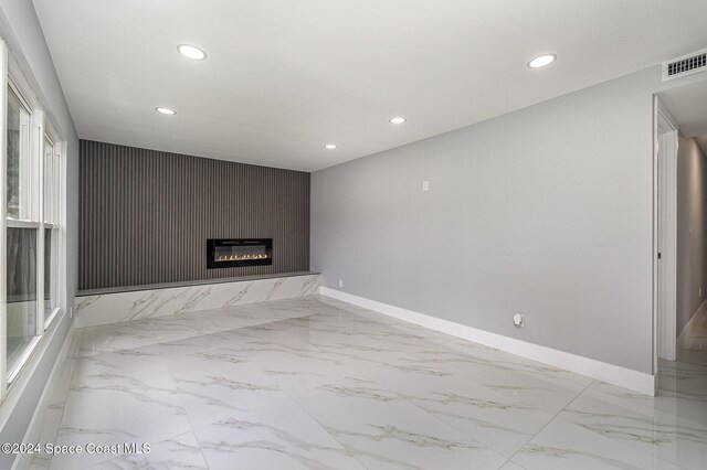 unfurnished living room with a large fireplace