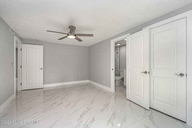 unfurnished bedroom with ceiling fan and ensuite bathroom