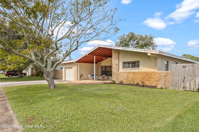 view of front of home featuring a garage and a front lawn