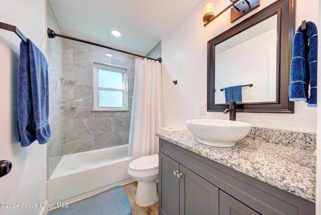 full bathroom featuring shower / bath combo, hardwood / wood-style floors, vanity, and toilet