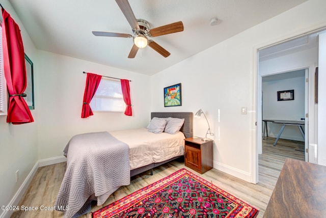 bedroom with light hardwood / wood-style flooring and ceiling fan