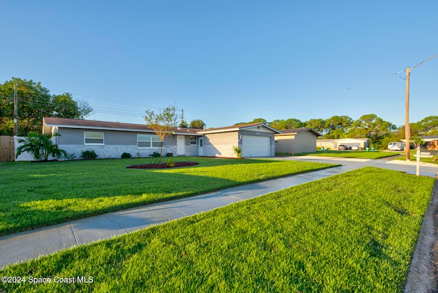 single story home featuring a garage and a front yard