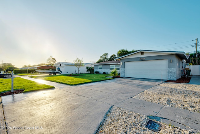 ranch-style house with a front yard and a garage