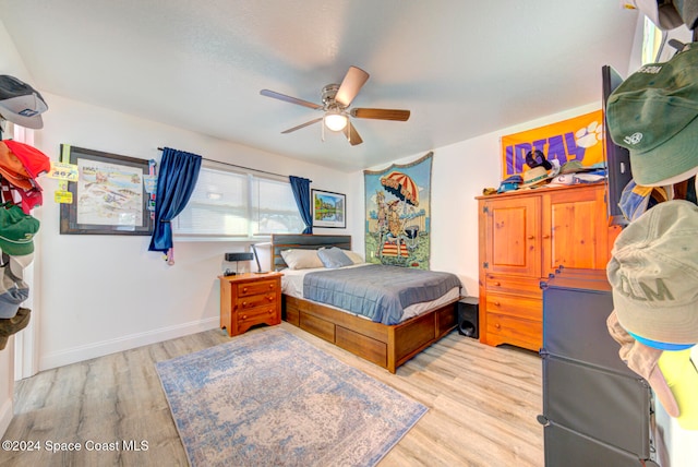 bedroom with ceiling fan and light hardwood / wood-style flooring