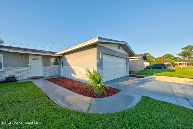 ranch-style home with a garage and a front yard