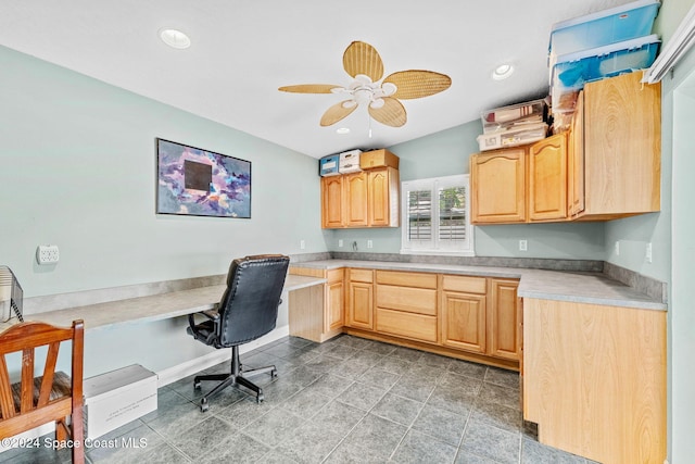 office space featuring ceiling fan and built in desk