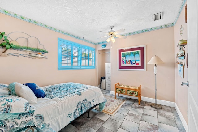 bedroom featuring ceiling fan, a textured ceiling, and a closet