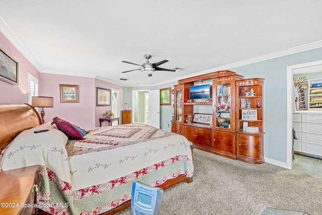 bedroom featuring ornamental molding, carpet flooring, ceiling fan, and ensuite bath