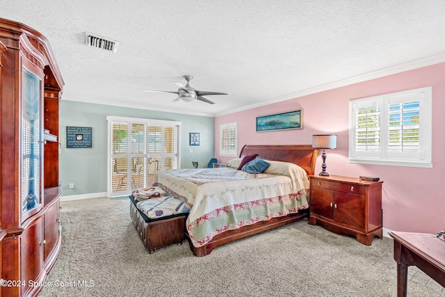 bedroom featuring light carpet, crown molding, multiple windows, and a textured ceiling