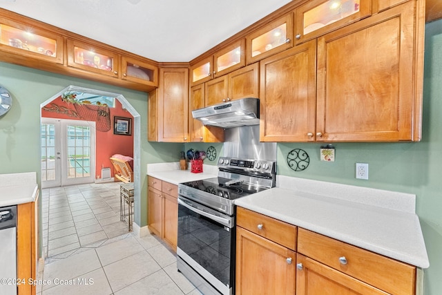 kitchen featuring french doors, appliances with stainless steel finishes, and light tile patterned floors