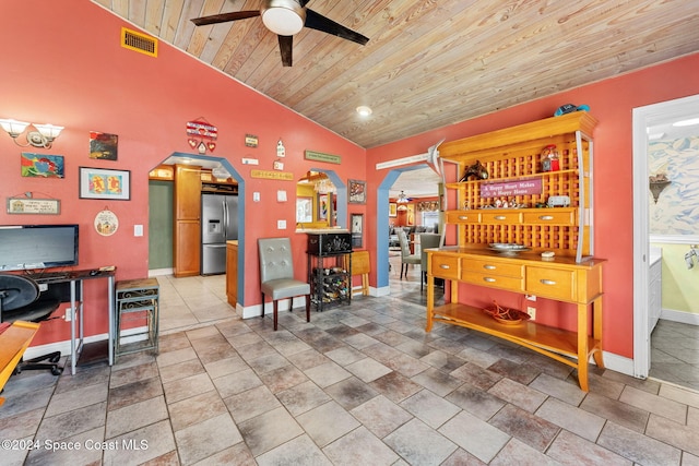 interior space featuring wooden ceiling, stainless steel refrigerator with ice dispenser, ceiling fan, and lofted ceiling