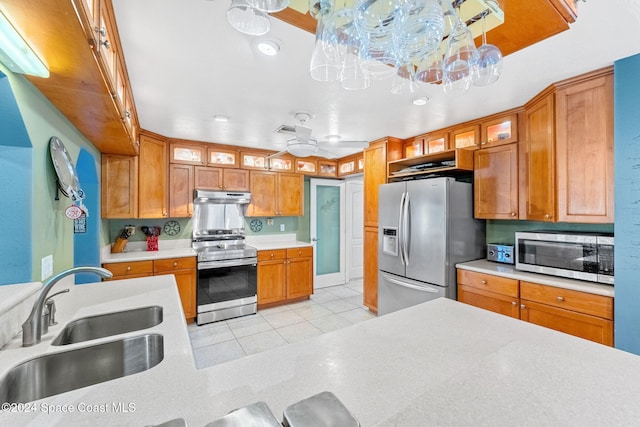 kitchen featuring sink, light tile patterned floors, appliances with stainless steel finishes, pendant lighting, and ceiling fan