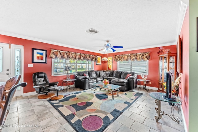 living room with a wealth of natural light, a textured ceiling, ceiling fan, and crown molding