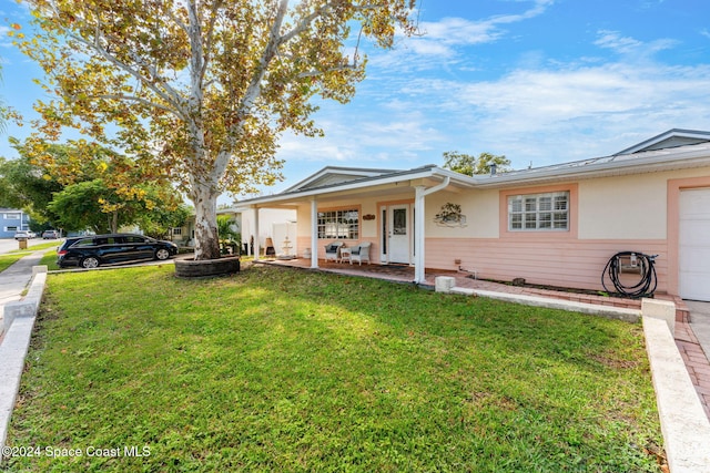 ranch-style house with a front yard and covered porch