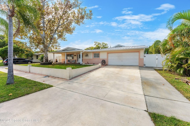 single story home featuring a garage and a front lawn