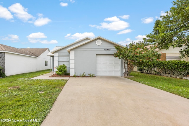 view of front of house with a garage and a front yard