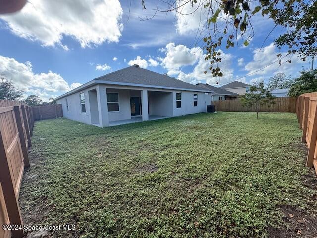 back of property with a lawn