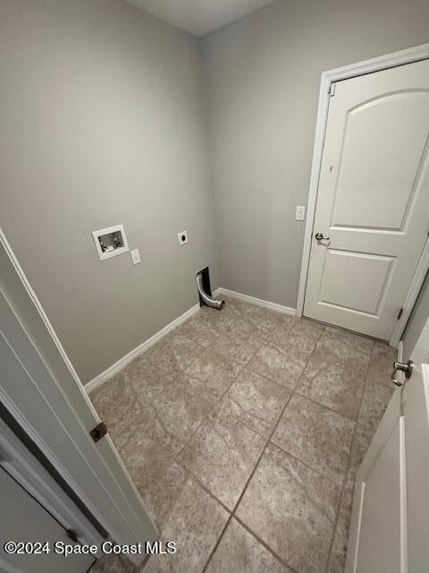 laundry area featuring washer hookup, light tile patterned floors, and hookup for an electric dryer