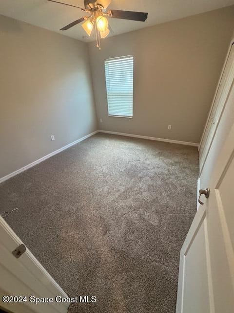 empty room with carpet flooring and ceiling fan