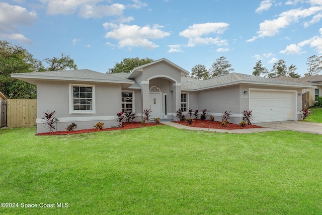 view of front of home with a front lawn and a garage