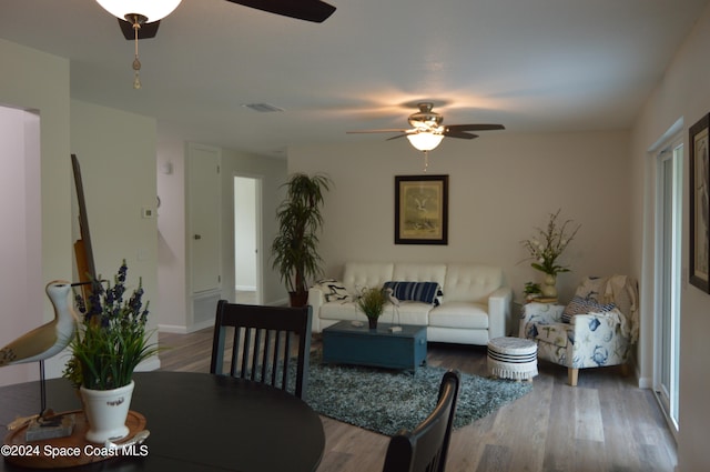 living room featuring hardwood / wood-style flooring and ceiling fan