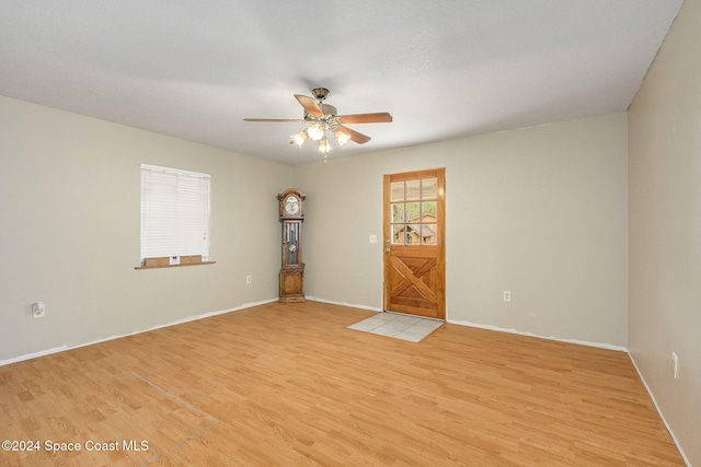 spare room featuring light hardwood / wood-style floors and ceiling fan