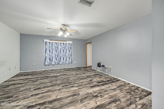 empty room with hardwood / wood-style floors, ceiling fan, and a textured ceiling