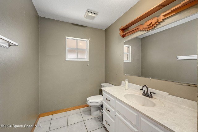 bathroom with tile patterned floors, vanity, toilet, and a textured ceiling