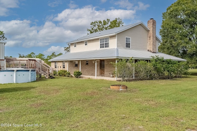 back of property featuring a yard