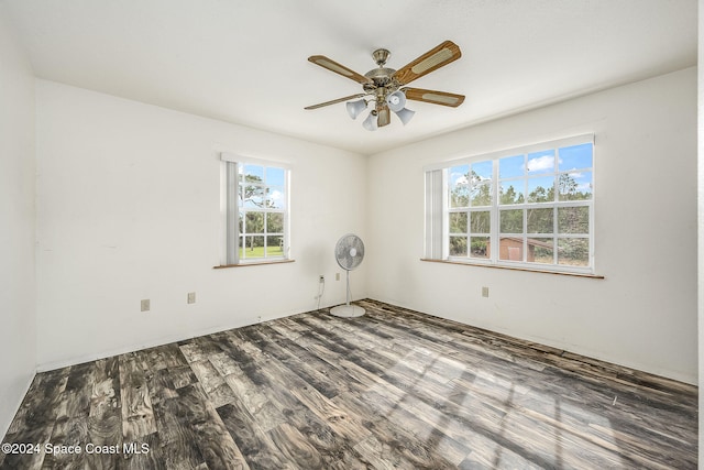 empty room featuring ceiling fan, a healthy amount of sunlight, and hardwood / wood-style flooring