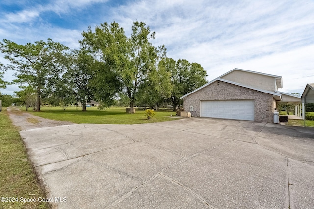 exterior space featuring a lawn and a garage