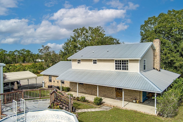 back of house featuring a wooden deck