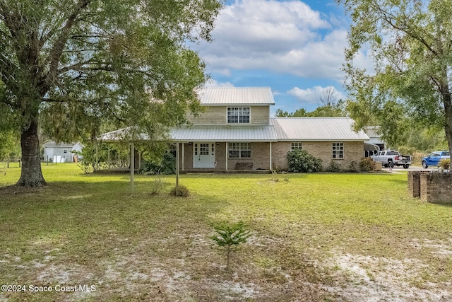 rear view of property with a lawn