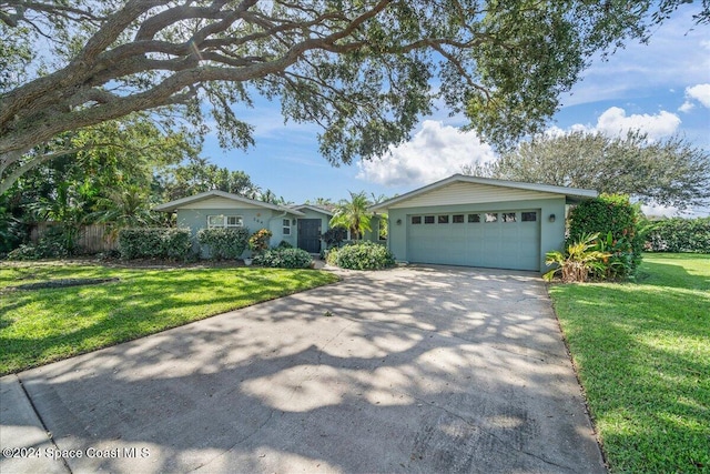 ranch-style home featuring a front yard and a garage