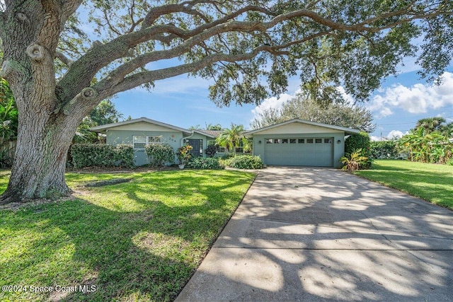 ranch-style home with a front yard and a garage