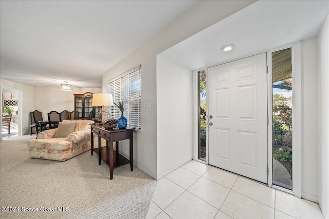 tiled entrance foyer with plenty of natural light and a textured ceiling