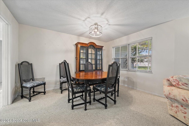 dining space featuring a textured ceiling and a notable chandelier