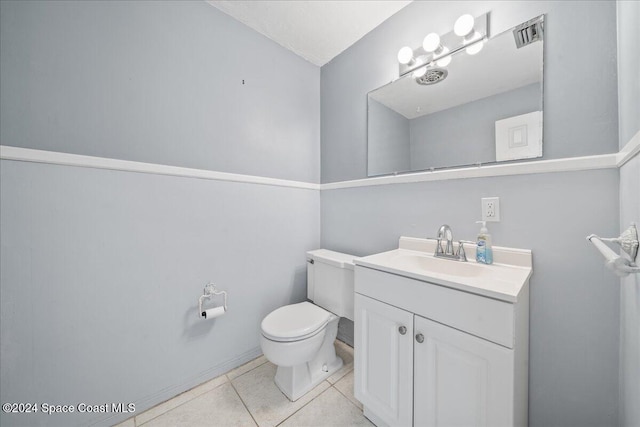 bathroom featuring toilet, vanity, and tile patterned floors