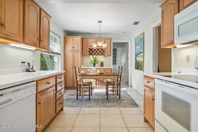 kitchen featuring white appliances, hanging light fixtures, and light tile patterned floors