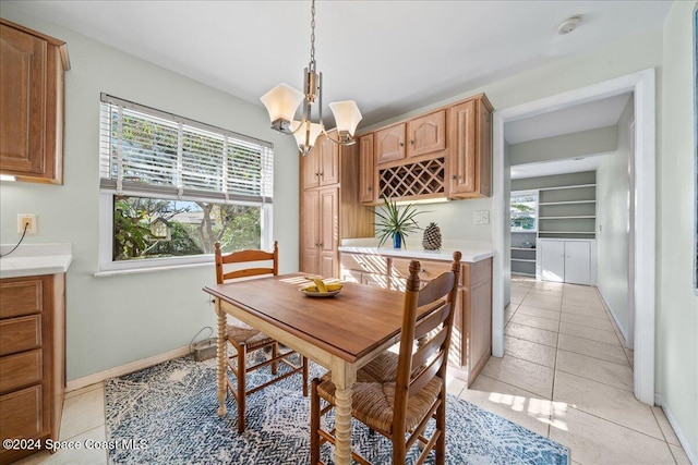 tiled dining room featuring an inviting chandelier